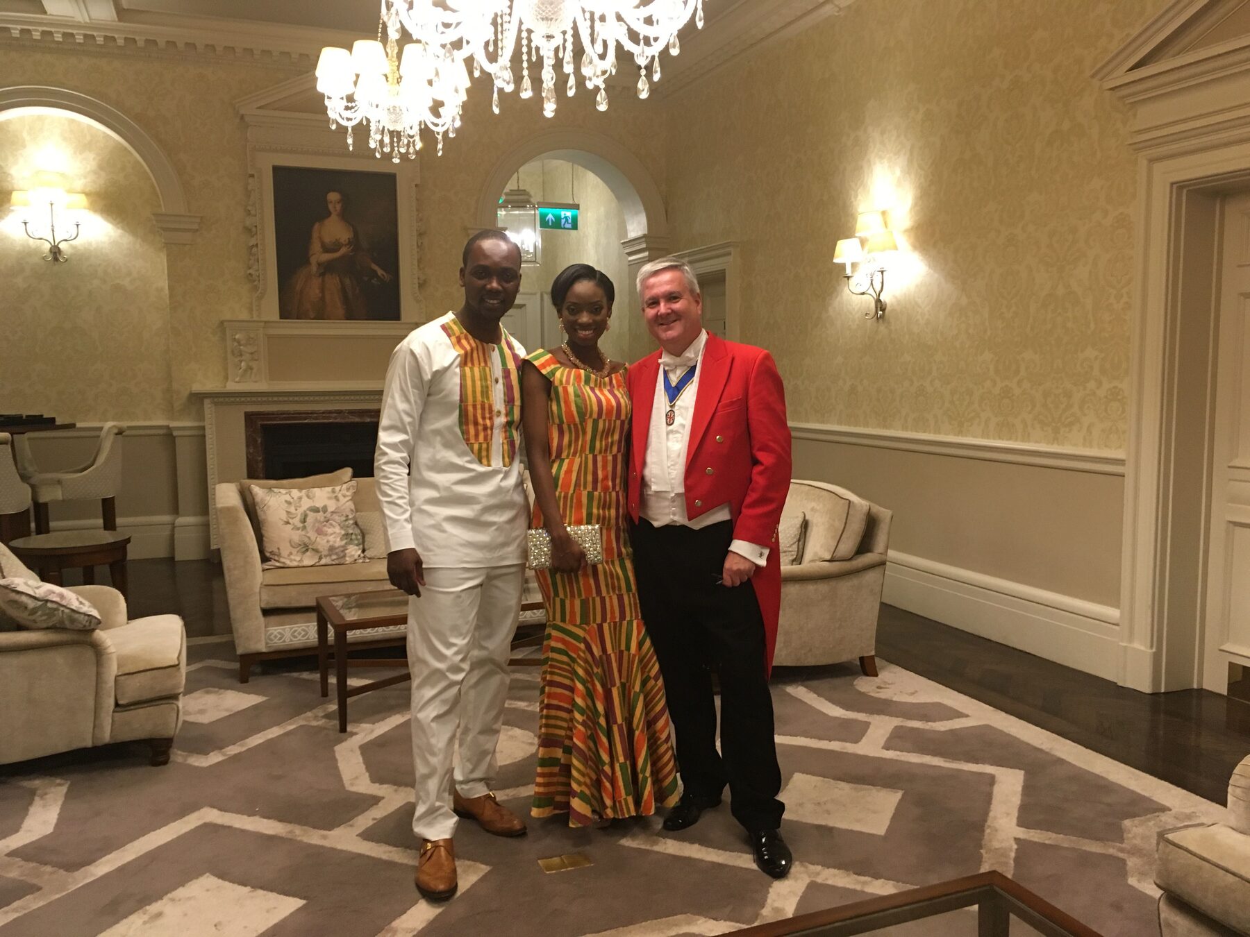 Andrew Morgan with a couple at their wedding celebration